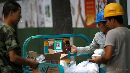 worker-scans-a-wechat-pay-qr-code-to-buy-takeaway-meal-for-lunch-near-a-construction-site-following-the-coronavirus-disease--covid-19--outbreak-in-beijing-1